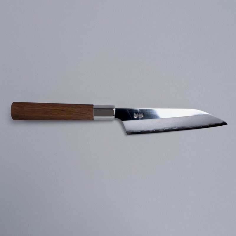 Ginsan stainless Petty knife 135mm crafted by Kurotori Blacksmith displayed horizontally on grey background
