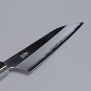 Closeup on blade of ginsan stainless Petty knife 135mm crafted by Kurotori Blacksmith on grey background