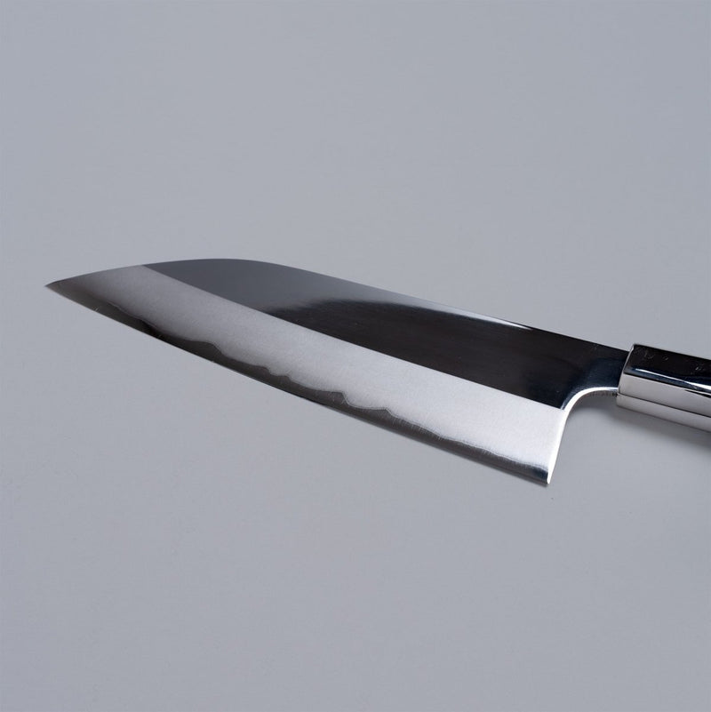 Closeup on reverse edge of ginsan stainless Funayuki knife 165mm crafted by Kurotori Blacksmith on grey background