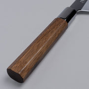Closeup on wooden handle of ginsan stainless Funayuki knife 165mm crafted by Kurotori Blacksmith on grey background