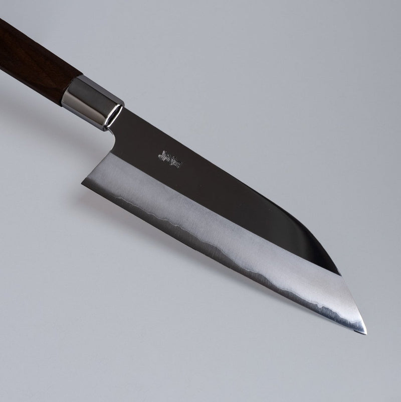 Closeup on tip of  ginsan stainless Funayuki knife 165mm crafted by Kurotori Blacksmith on grey background