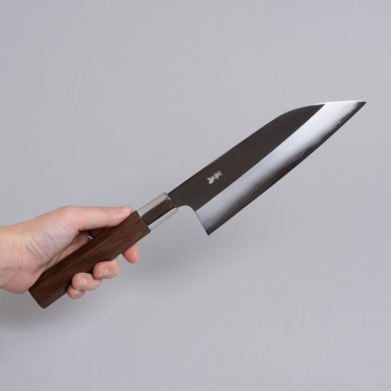 Hand holding ginsan stainless Funayuki knife 165mm crafted by Kurotori Blacksmith on grey background