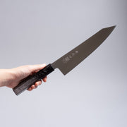 Hand holding a Inoguchi Hamono Japanese Kiritsuke Santoku Knife 210mm (Japanese Oak Urushi Lacquer Black)