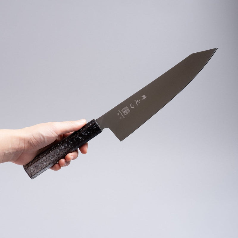 Hand holding a Inoguchi Hamono Japanese Kiritsuke Santoku Knife 210mm (Japanese Oak Urushi Lacquer Black)