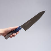 Hand holding a Inoguchi Hamono Japanese Kiritsuke Santoku Knife 210mm (Japanese Oak Urushi Lacquer Blue)