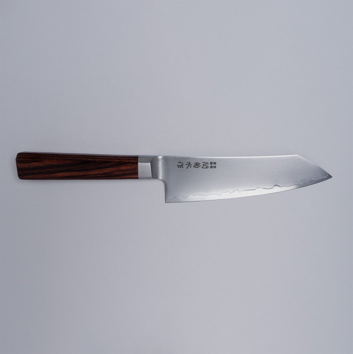 VG-10 stainless steel KIRINAMI Kiritsuke Bunka 150mm crafted by Seki Kikusui Cutlery displayed horizontally on grey background