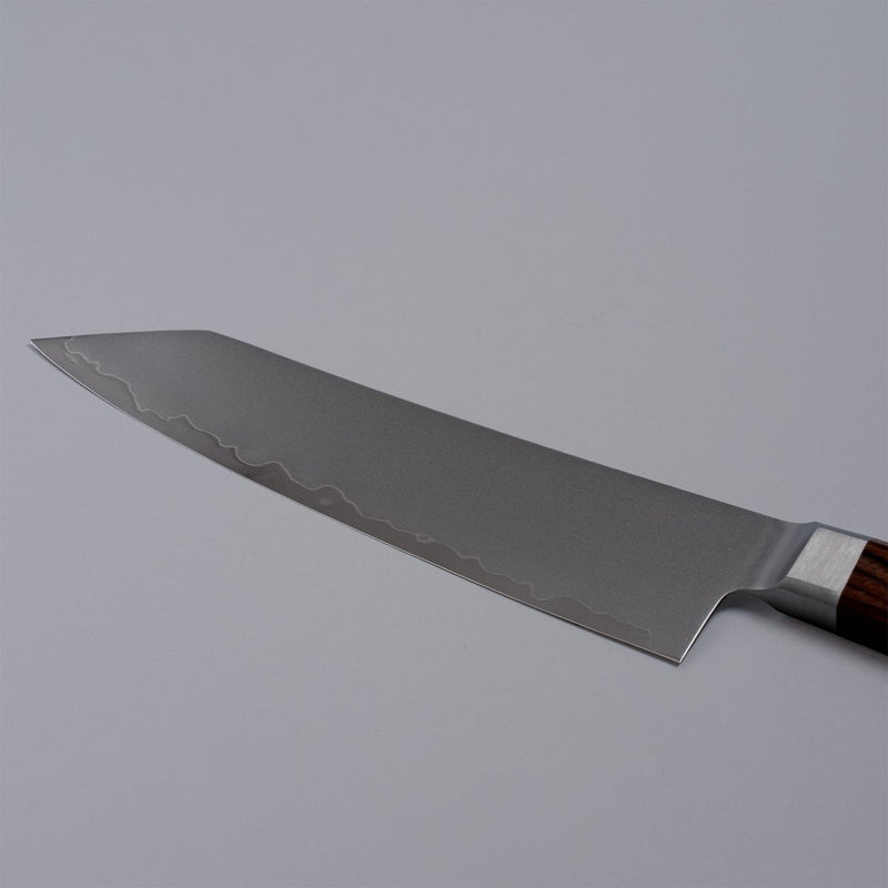 Closeup on reverse side of blade of VG-10 stainless steel KIRINAMI Kiritsuke Bunka 180mm by Seki Kikusui Cutlery on grey background