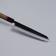 Closeup on tip of Kurouchi Damascus Blue Steel No. 2 Kiritsuke 210mm by Kajihara Hamono on grey background