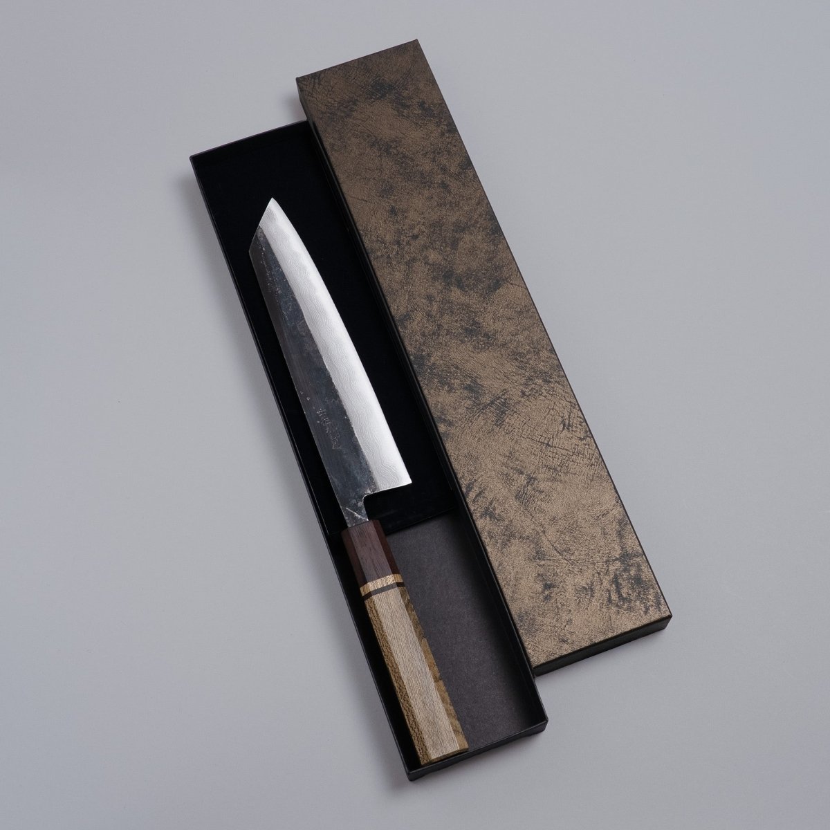 Kurouchi Damascus Blue Steel No. 2 Kiritsuke 210mm by Kajihara Hamono in box on grey background