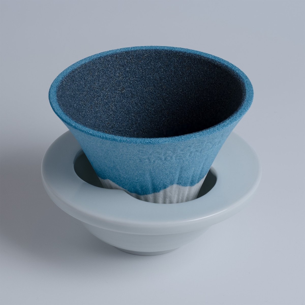 Closeup of COFIL Mount Fuji Ceramic Coffee Filter mounted on the saucer