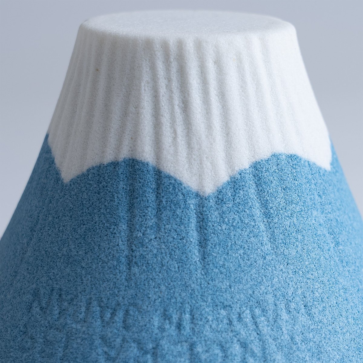 Closeup of the white and blue top for the COFIL Mount Fuji Ceramic Coffee Filter with the porous texture