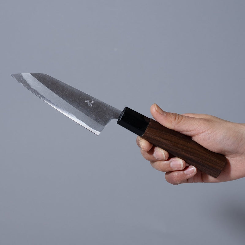 Hand holding a Nishida Hamono Polished Petty Knife 100mm