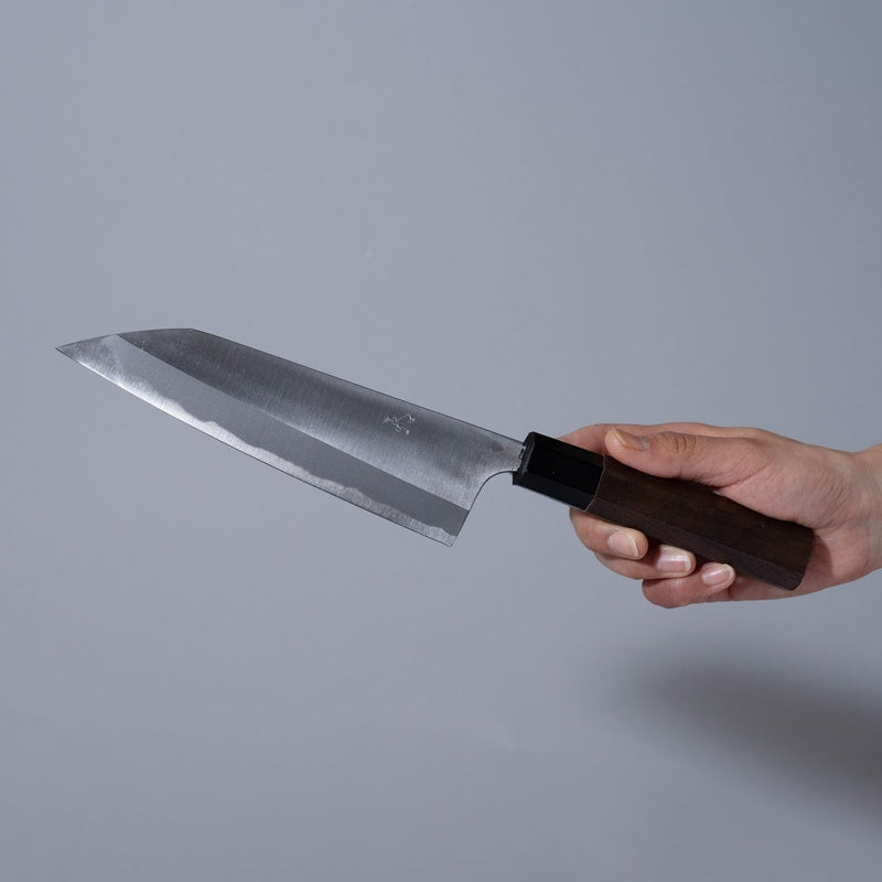 Hand holding a Nishida Hamono Polished Gyuto Knife 165mm