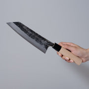 Hand holding a Nakamura Hamono Curved Back Bunka Kitchen Knife 165mm