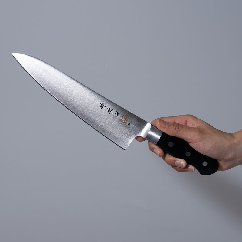Hand holding a Inoguchi Hamono Western Santoku Knife 21cm