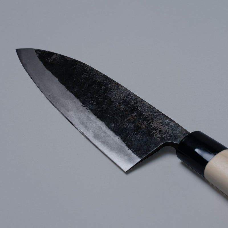 Closeup of the balde of a Nakamura Hamono Kurouchi Deba Knife 210mm with maker's name engraved