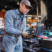 Hidetoshi Miwa, master artisan of Miwa Hamono, hammering a blade