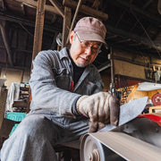 Hidetoshi Miwa, from Miwa Hamono, polishing a blade