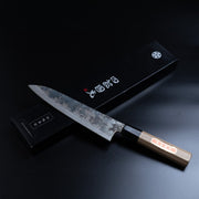 Shirou Kunimitsu Special White Steel Kurouchi Gyuto Knife 210mm in front of the black box with the artisan name in Japanese characters