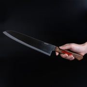 Hand holding a Shirou Kunimitsu Stainless Steel Gyuto Knife 230mm