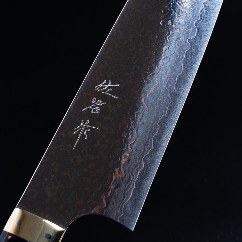 Closeup on engraving on Takeshi Saji VG-10W Stainless Steel Gyuto 230mm on a dark background