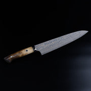 Takeshi Saji VG10W Stainless Steel Gyuto 240mm Gold-Toned Finish displayed diagonally on black background