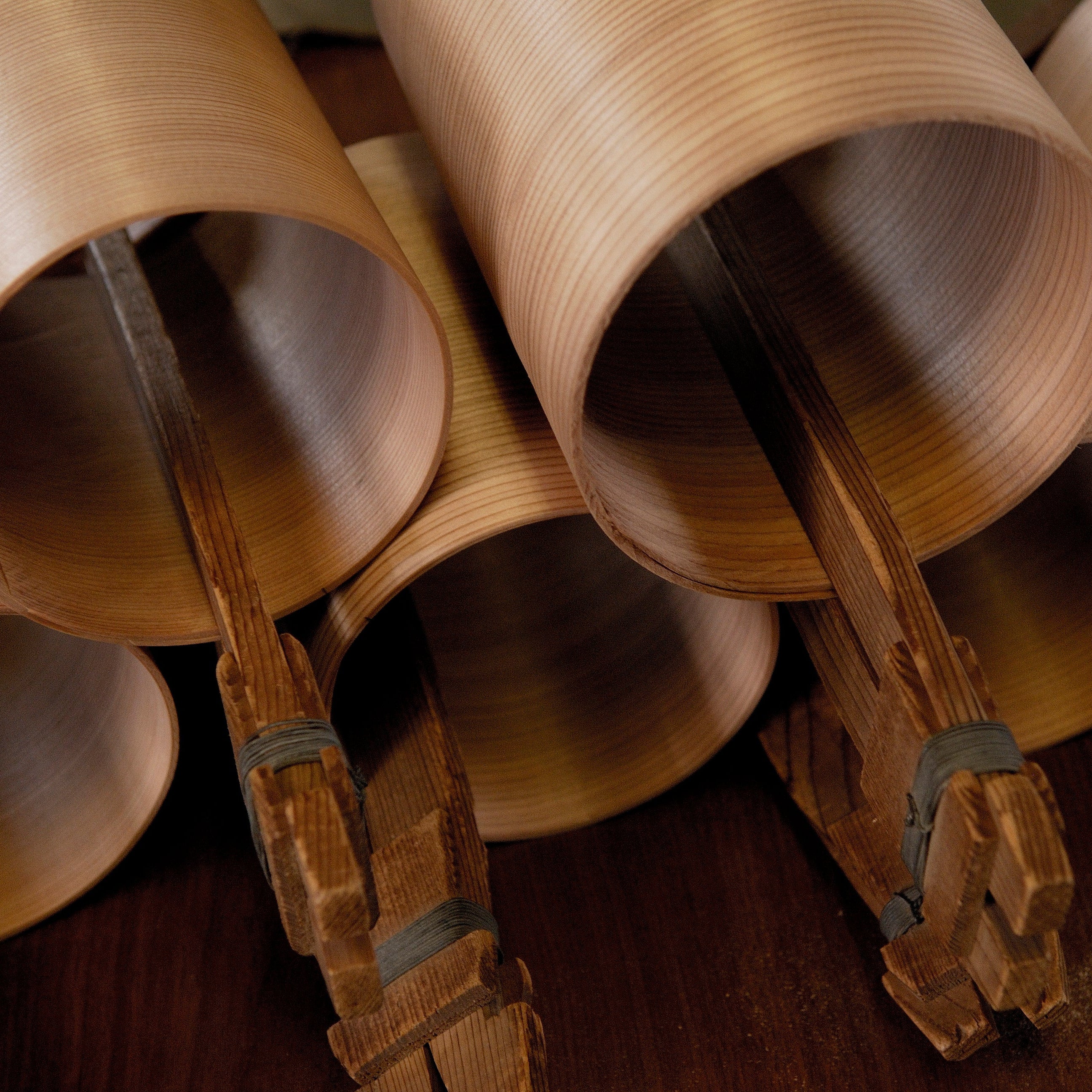 Closeup of wooden pieces in round shapes inside Hakata Bentwood Tamaki workshop