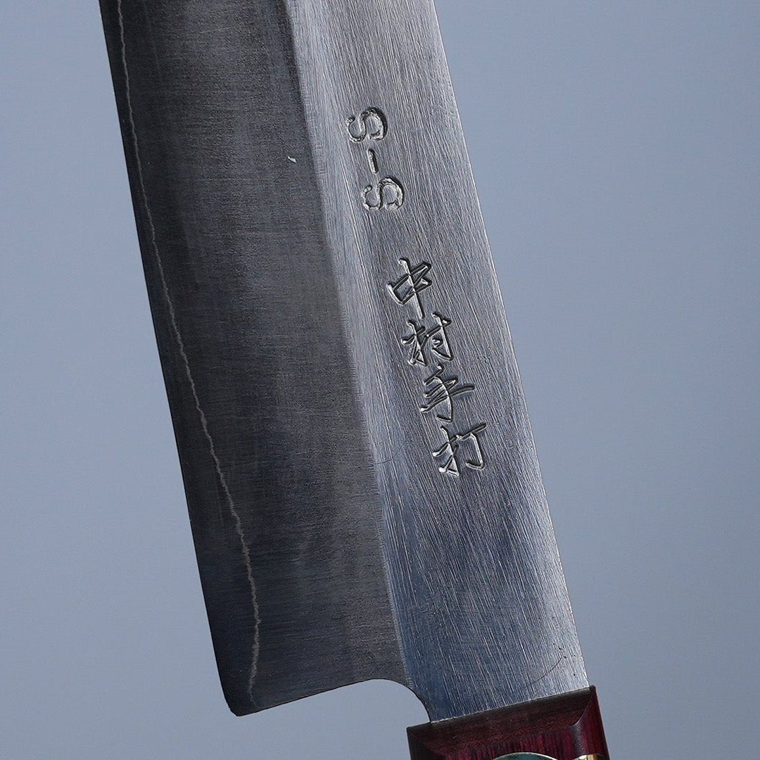 Closeup of the artisan name engraving on the blade of a Nakamura Blacksmith HAP40 Gyuto 200mm