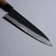 Closeup on tip of Kyohei Shindo Kurouchi Gyuto 220mm crafted from Aogami 2 in Kochi Japan on grey background