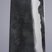 Closeup on engraving on Kyohei Shindo Kurouchi Knife crafted from Aogami 2 in Kochi, Japan on grey background