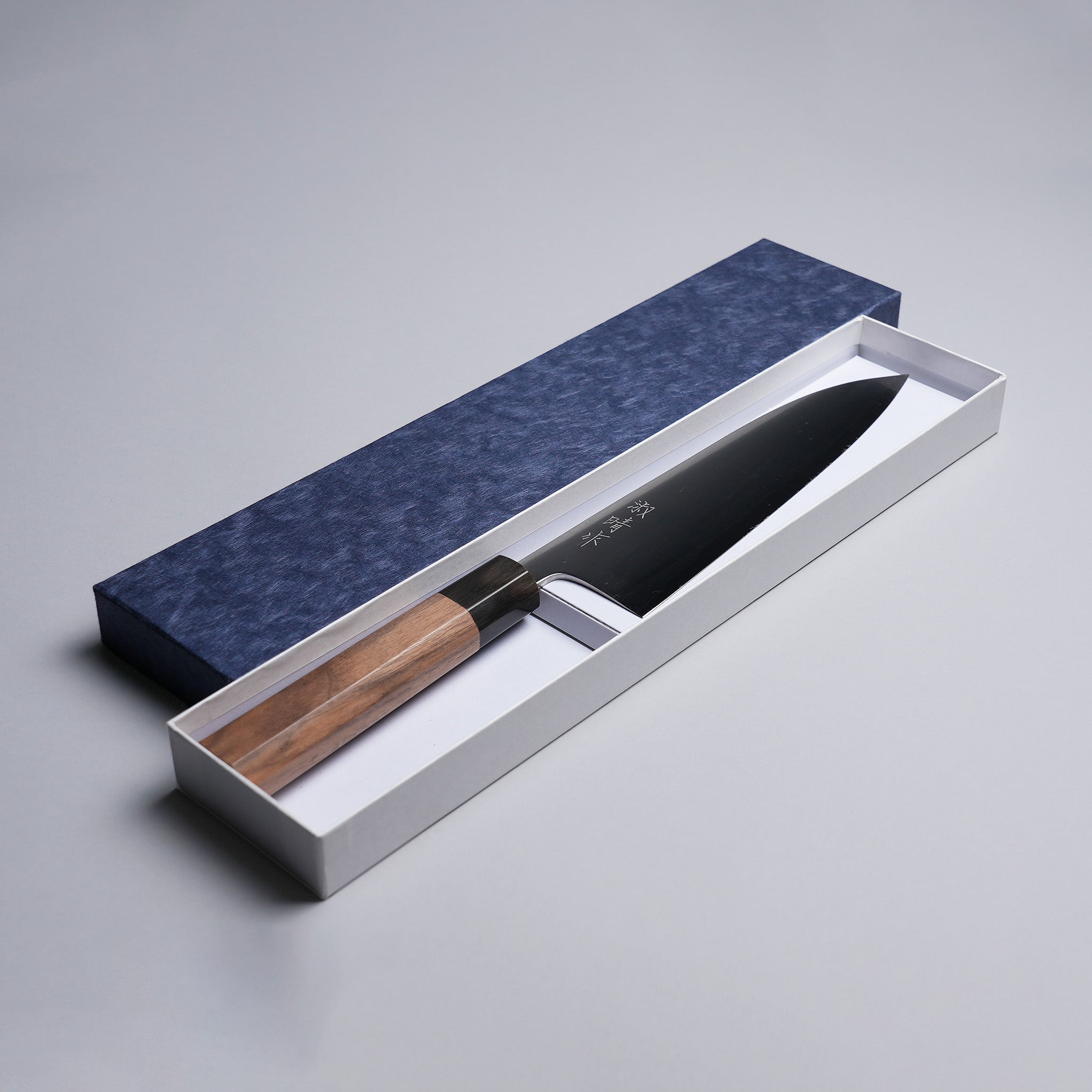Sakoda Hamono Polished Aogami Super Gyuto 180mm in decorative box on grey background