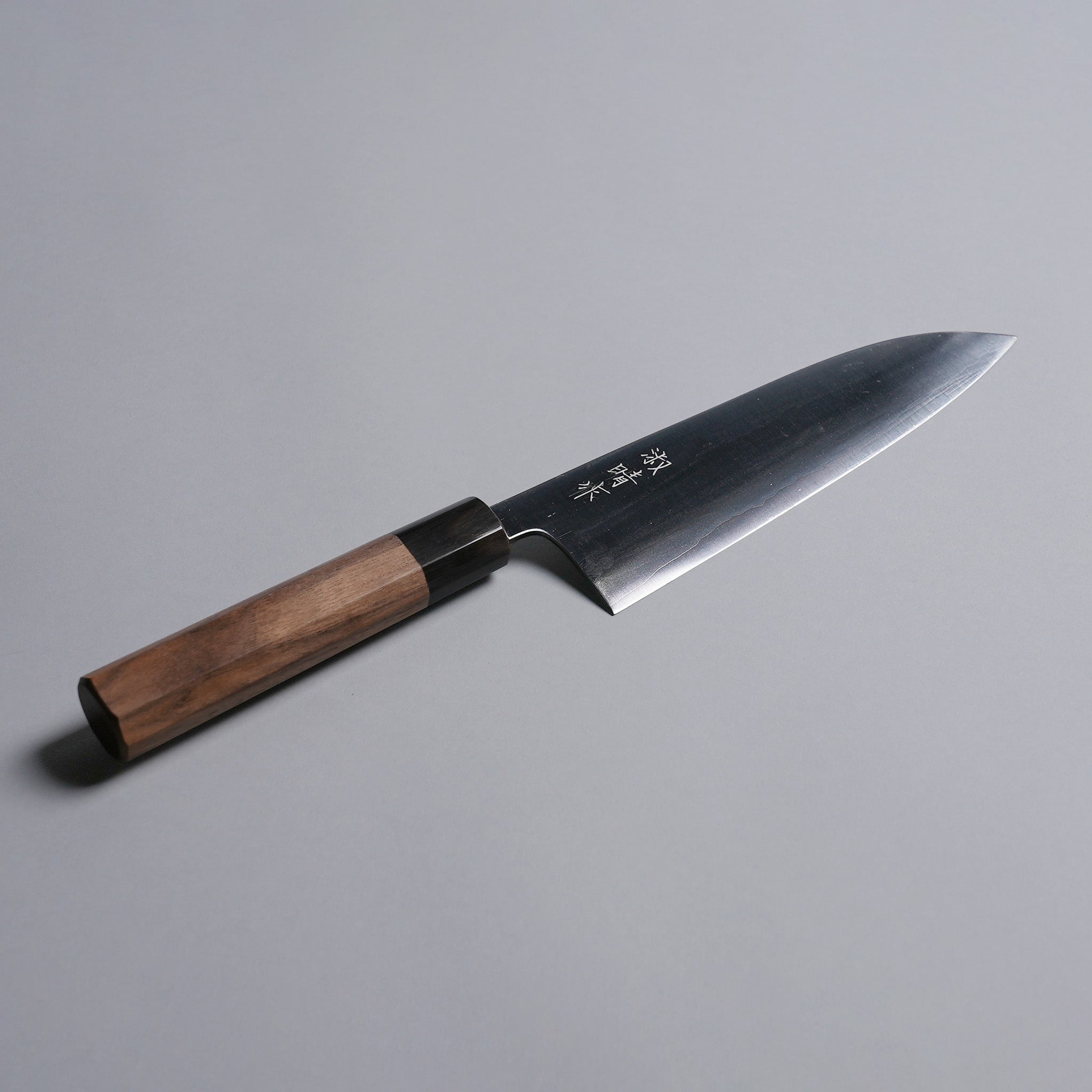 Sakoda Hamono Polished Aogami Super Gyuto 180mm displayed diagonally on grey background