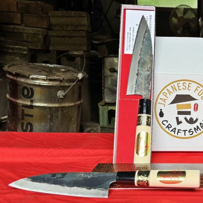 Two Kurouchi Deba Knives 155mm by Shigemitsu Hamono in workshop on red table