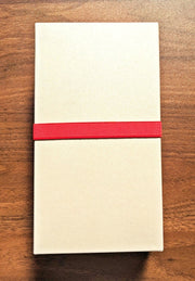 Closed box of the 'Happa' Leaf Shaped All - Around Knife by Asano Blacksmith in beige with a red strap around