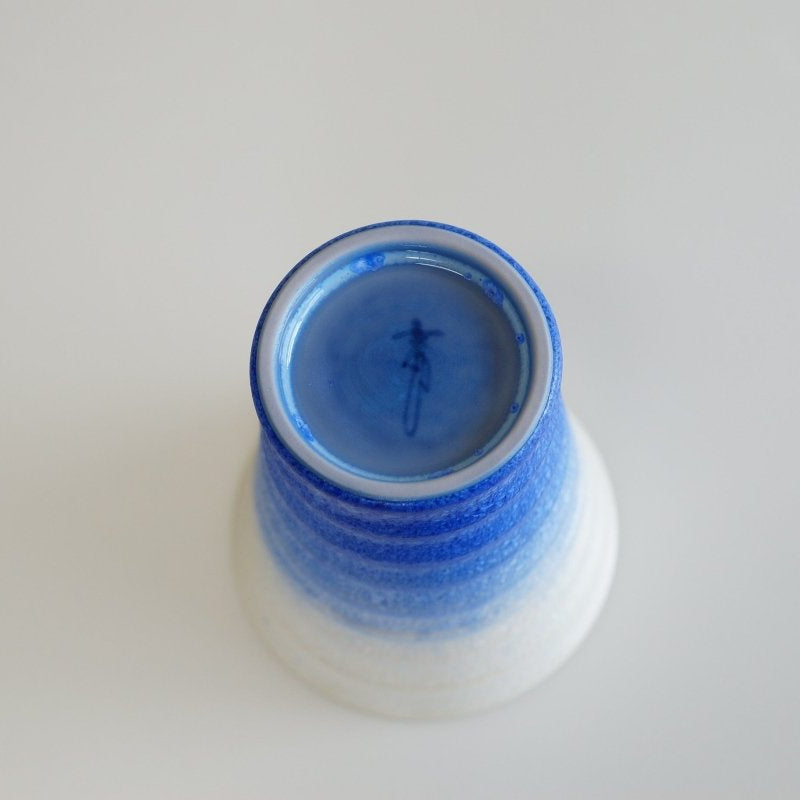 View of base of indigo-white gradient Ceramic Aritaware Cup by Imari Togei craftsmen on white background