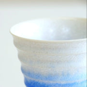 Closeup on top edge of Indigo-white gradient Ceramic Aritaware Cup by Imari Togei craftsmen on white background