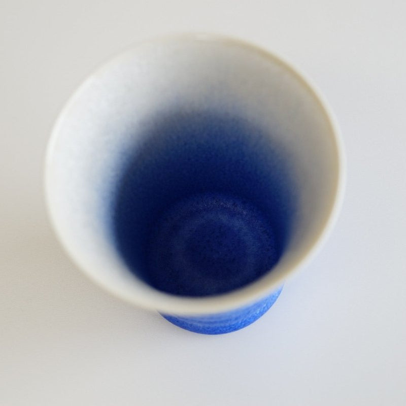 Aerial view of inside of indigo-white gradient Ceramic Aritaware Cup by Imari Togei craftsmen on white background