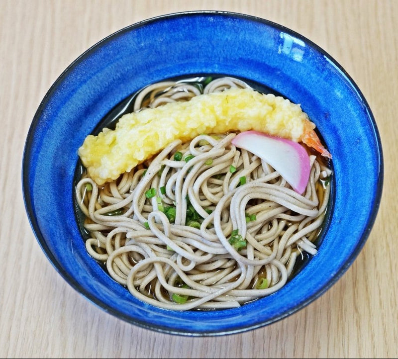 Soba noodles with tempura served in Blue Glazed Bowl crafted by Imari Togei craftsmen on wood background