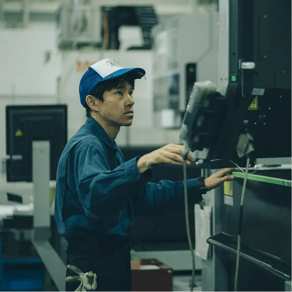 A Fukuda Hamono artisan inside the workshop machinery
