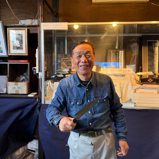 Master swordsmith Ueta Norihito, from Bizen Osafune Blacksmith, holding a hand-forged knife at his forge in Osafune, Okayama, Japan