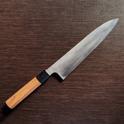 Bizen Osafune Tamahagane Gyuto Knife 212mm at an angle showcasing the folded steel blade surface and magnolia wood handle