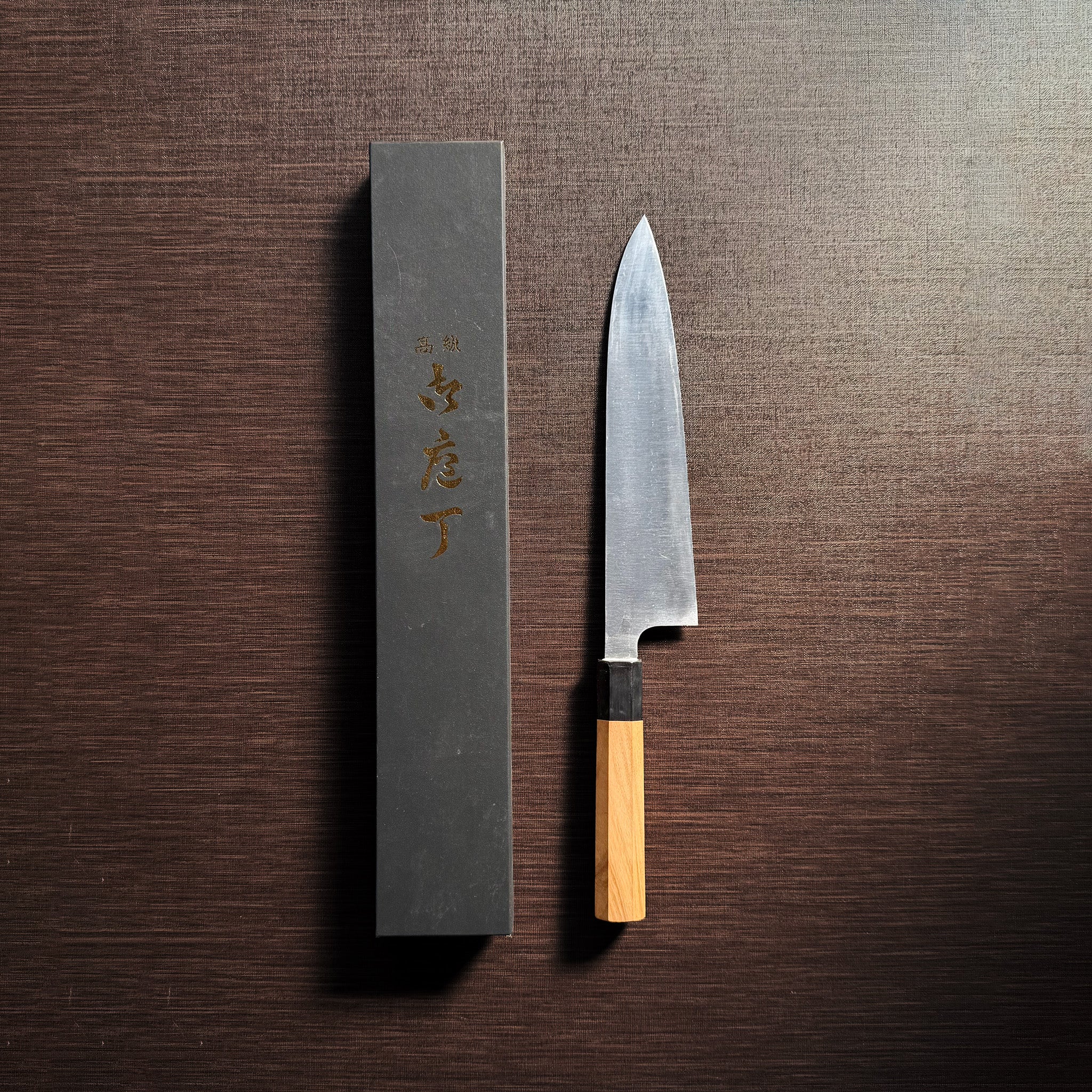 Bizen Osafune Tamahagane Gyuto Knife 212mm with its black presentation box, hand-forged by master swordsmith Ueda Sukesada