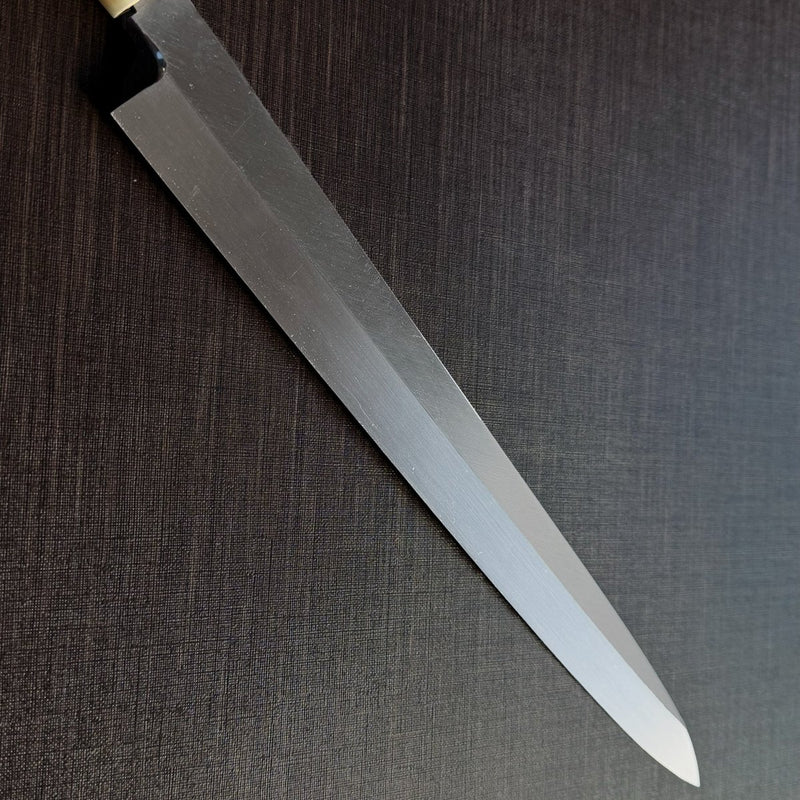 Close-up of the Bizen Osafune Tamahagane Sashimi Knife 310mm blade showing the mirror-polished tamahagane steel surface