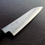 Close-up of the Bizen Osafune Tamahagane Santoku Knife 175mm blade showing the jihada folded steel grain and engraved 祐定 signature