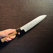 Bizen Osafune Tamahagane Santoku Knife 175mm held in hand showcasing the magnolia wood handle and tamahagane steel blade