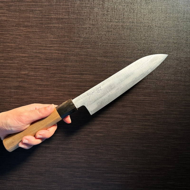 Bizen Osafune Tamahagane Santoku Knife 175mm held in hand showcasing the magnolia wood handle and tamahagane steel blade