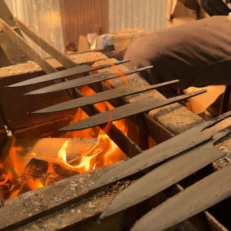 Closeup of Sakoda Hamono gyuto blades over the fire forge