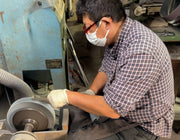 Craftsman at Sakoda Hamono sharpening a knife in his workshop in Kochi, Japan