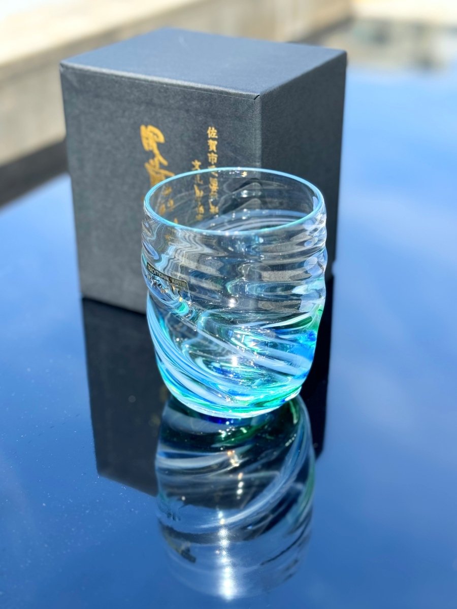 Handcrafted Cobalt Green Wavy Glass by Soejima Glassware displayed on reflective blue-black surface next to black box