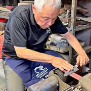 Seki Kikusui craftsman sharpening VG-10 stainless steel KIRINAMI Kiritsuke Bunka by hand in his workshop